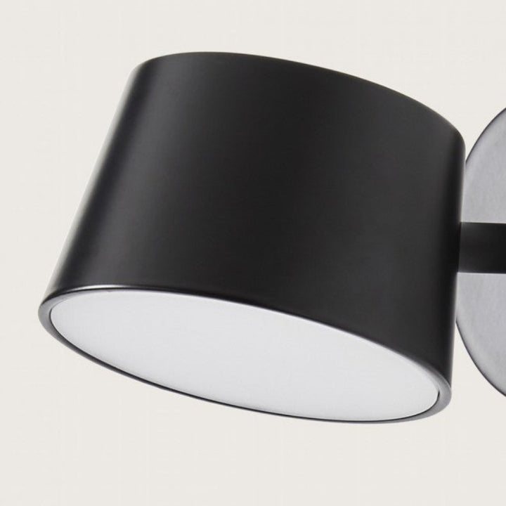 Black wall-mounted light fixture on a white background