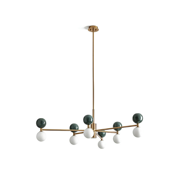 A contemporary ceiling-mounted chandelier with a bronze-colored steel structure, green glass pendants, and white spherical elements.
