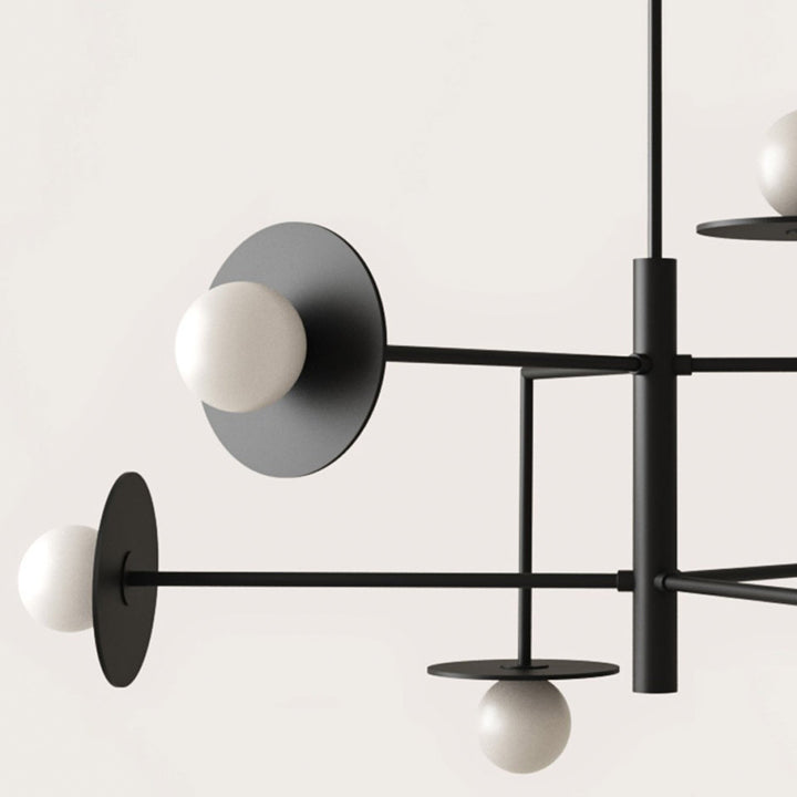 Modern chandelier with black metal frame and white spherical lights on a white background