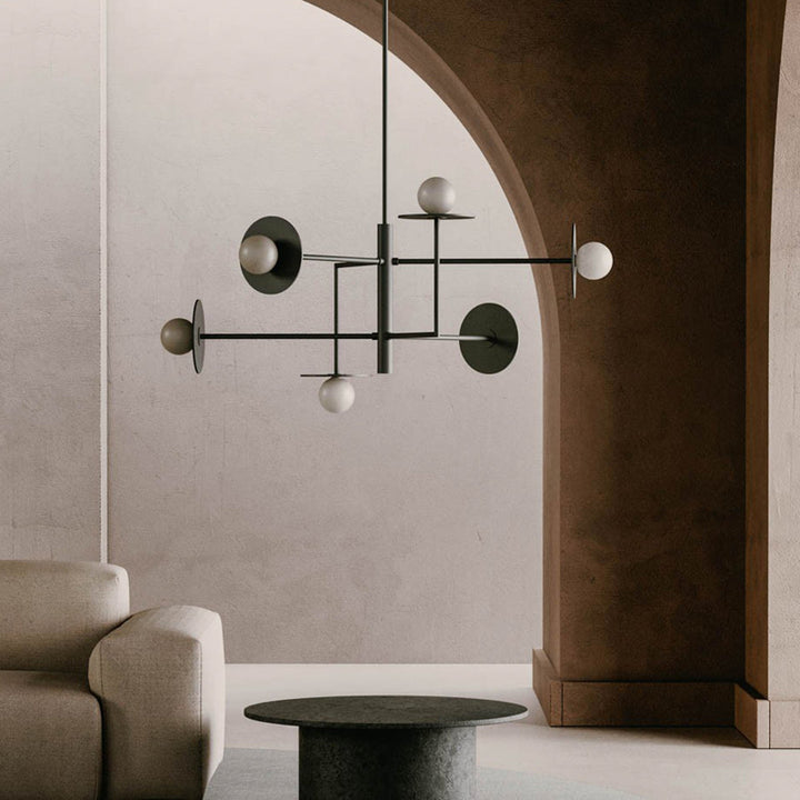Modern chandelier hanging in a room with a neutral color palette by Bazar Mondiale