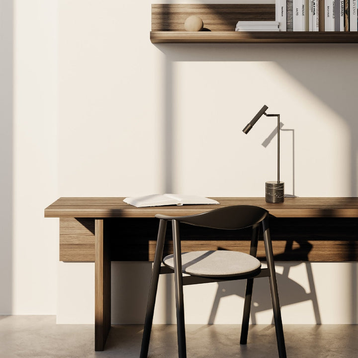 Modern home office with wooden desk, chair, and shelves.