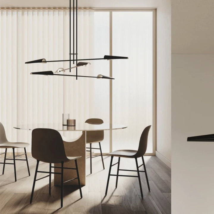 Modern dining area with glass table and chairs in a minimalistic setting