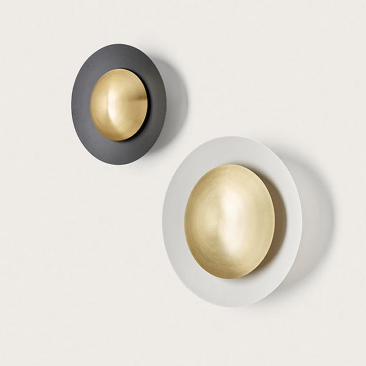 Two wall sconces, one gold and gray, the other gold and white, on a light gray background.