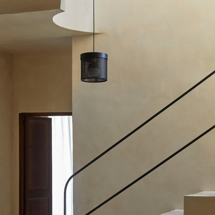 Modern staircase with a black metal railing and pendant light fixture.