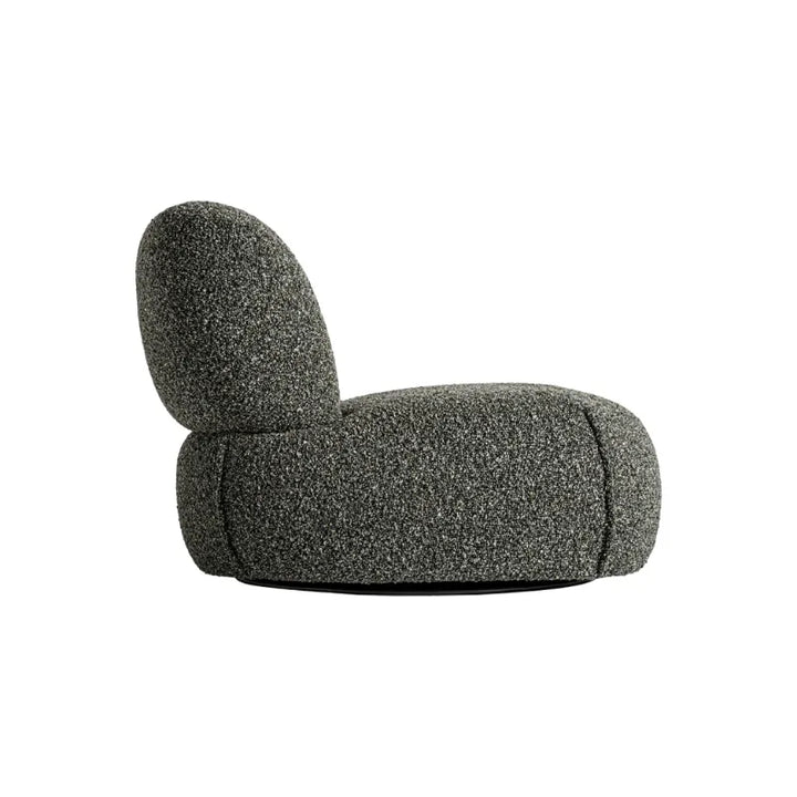 Rear angle of Ken Armchair showcasing sculptural backrest and plush seat.Only at Bazar Mondiale high end furniture and exclusive pieces.