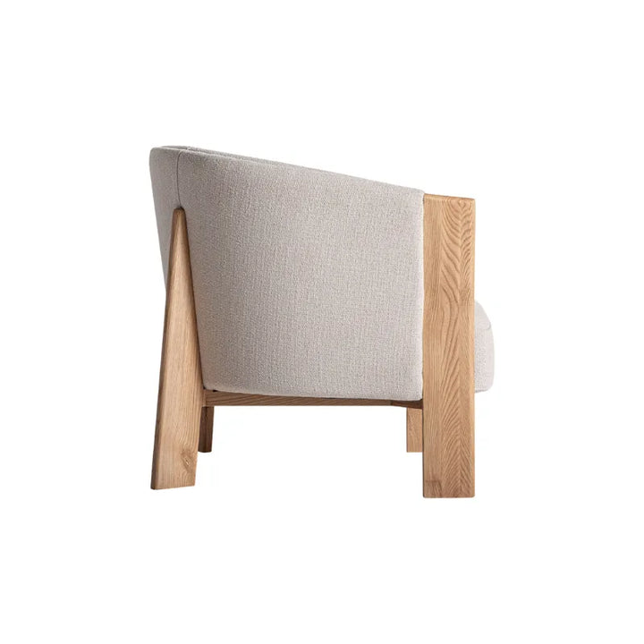 Detail of oak wood frame and beige upholstery on Nara chair – Only at Bazar Mondiale high end furniture and exclusive pieces. Only at Bazar Mondiale high end furniture and exclusive pieces.