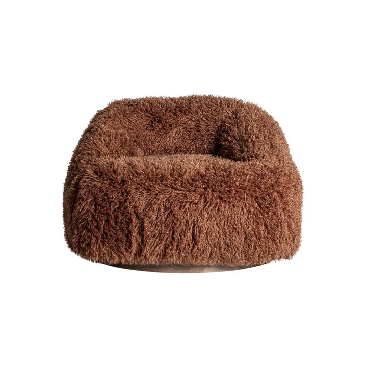 Rear view of Pavia Armchair with sculpted plush form and circular base. Only at Bazar Mondiale high end furniture and exclusive pieces.