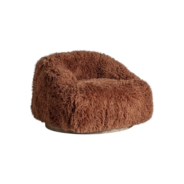 Close-up of Pavia Armchair showcasing terracotta shaggy boucle texture. Only at Bazar Mondiale high end furniture and exclusive pieces.