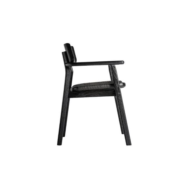 Rear view of the Tasque chair showing its curved backrest in solid black oak – Only at Bazar Mondiale high end furniture and exclusive pieces.